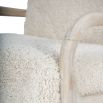 wooly upholstered armchair with washed wood frame