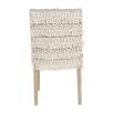 textured upholstered dining chair with tassel details and washed wood legs