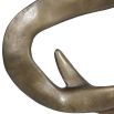 Gold wavy abstract sculpture on black plinth