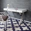 A contemporary desk with nickel crisscrossed legs and lucite handles 