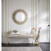 A chic grey velvet stool with an acrylic and brass frame
