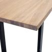 A rectangular natural oak desk with black iron legs