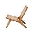 A luxurious teak and rattan lounge chair 