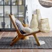 A luxurious teak and rattan lounge chair 