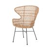 A luxurious woven rattan armchair with metal legs