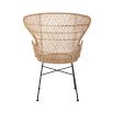 A luxurious woven rattan armchair with metal legs