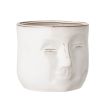 A glazed ceramic handcrafted flowerpot with abstract human facial features