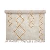 Cream and orange patterned wool rug with tassel details