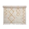 Cream and orange patterned wool rug with tassel details