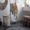 Luxurious circular black rug made from jute with tassels