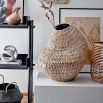 A simple and stylish black woven basket with natural handles