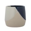 A graphic stoneware flowerpot with a matte and glazed textured finish