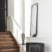 A luxurious capsule-shaped black wall mirror with a rectangular frame