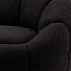 elegant black boucle upholstered swivel chair with brass base 