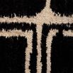 Black wool rug with cream ivory rectangular pattern detail