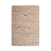 textured cream rug with black specs and a fringe