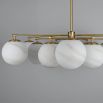 Elegant ceiling light with round white shades and brass fixture