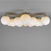 Elegant ceiling light with round white shades and brass fixture