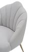 Light grey velvet chair with statement leaf backrest and tapered brass legs