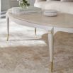 oval coffee table with golden detailings