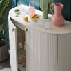 Glamorous contemporary bar cabinet with woven texture on the doors and silver base