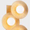 Wall light featuring five layered gold discs on gold wall fixture
