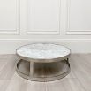 Opulent round table with white marble surface and silver frame