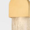 Luxurious wall lamp with brass hood mounted on travertine back