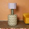 A luxury lampshade by Eva Sonaike with a purple African-inspired pattern