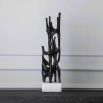Visually intriguing black sculpture on white marble base