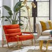 A mid-century modern inspired armchair with burnt orange velvet and a polished brass frame