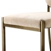 Elegant dining chair with greige upholstery and dark brass frame