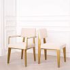 A luxurious modern brushed brass and boucle dining chair 