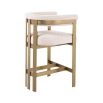 Glamorous brass frame counter stool and cream boucle upholstery