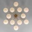 Elegant ceiling light with round white shades and brass fixture