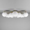 Elegant ceiling light with round white shades and brass fixture