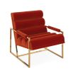 A mid-century modern inspired armchair with burnt orange velvet and a polished brass frame