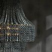 Grey beechwood chandelier with layered hand-carved circular beads 