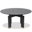 Smooth circular top dining table elevated by a sturdy geometric support