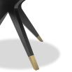 Dining table with statement base of slender spokes and brass caps