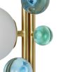 Jewel-toned acrylic and opaque white orbs float on brushed brass stem