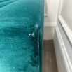 A luxurious teal-coloured 4-seater sofa