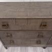 6-drawer chest of drawers with a brown oak finish and antique brass hardware 