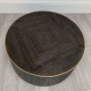 Striking round wooden coffee table with brass accents and some imperfections to the finish