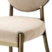 Elegant dining chair with greige upholstery and dark brass frame