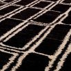 Black wool rug with cream ivory rectangular pattern detail