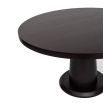 Smooth rounded top dining table elevated by a softly tapered cylinder base
