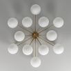 Elegant ceiling light with round white shades and brass fixture