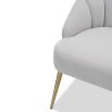 Light grey velvet chair with statement leaf backrest and tapered brass legs