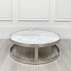 Opulent round table with white marble surface and silver frame